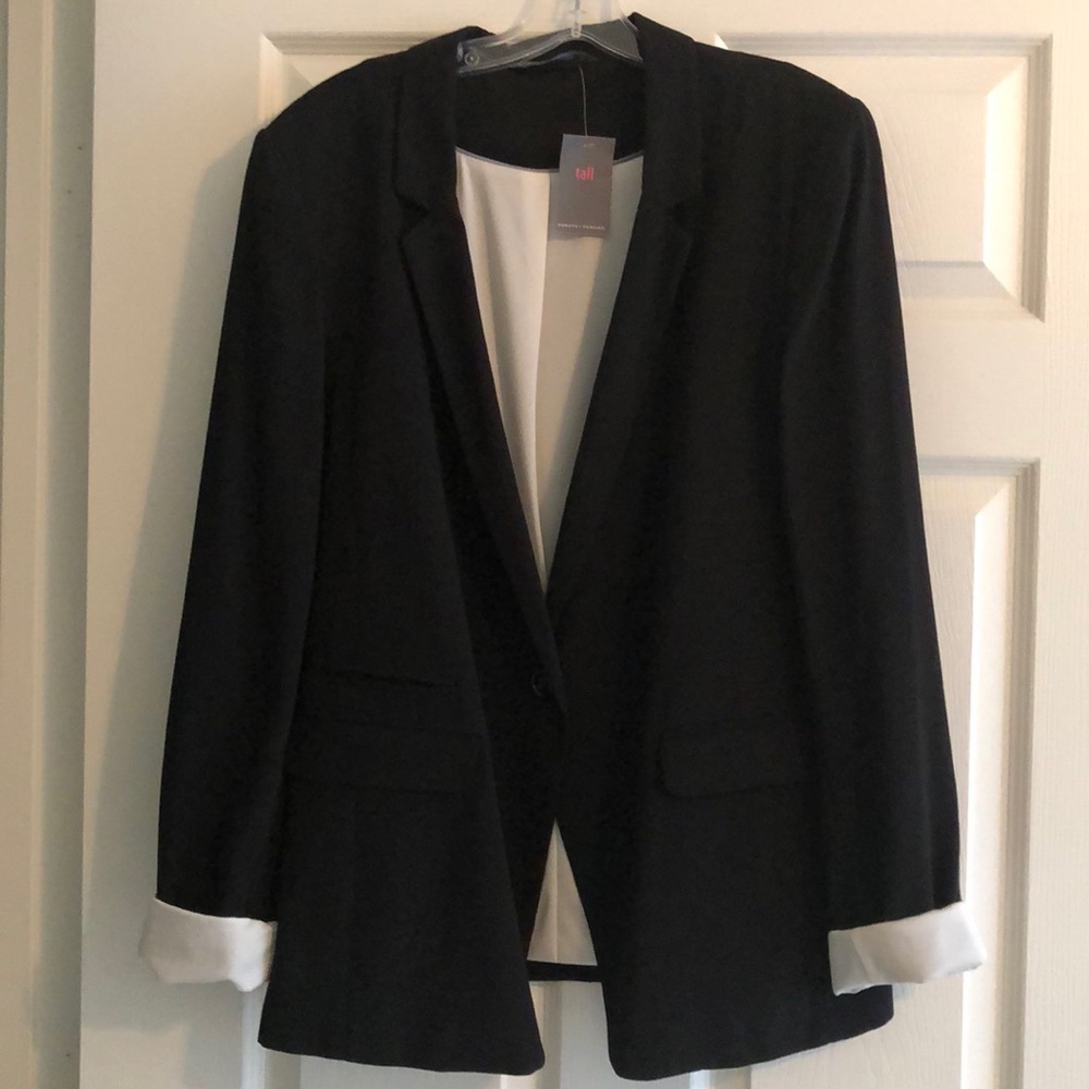 Black sports jacket with white cuffs.